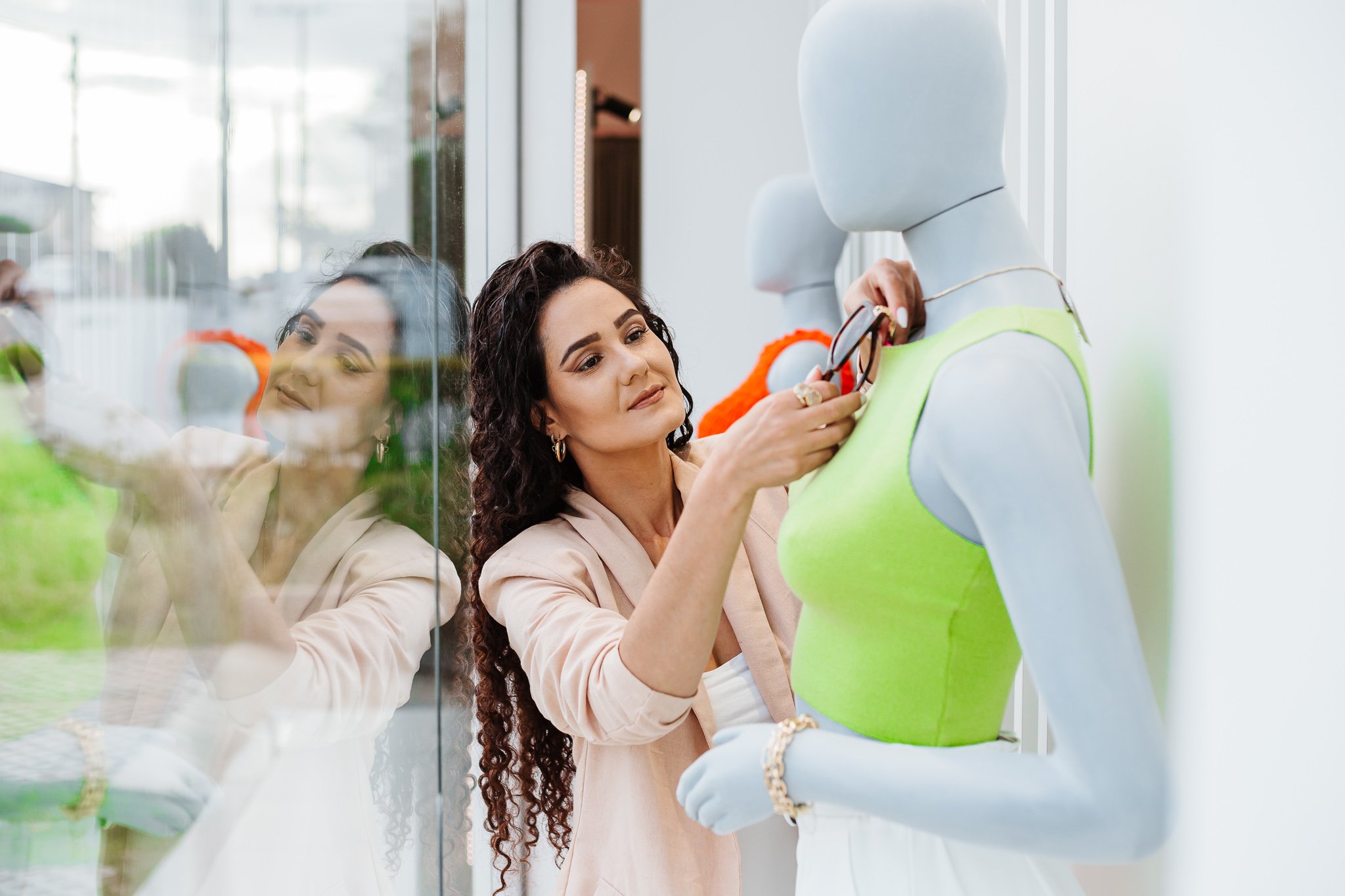 Luana Pereira montando uma vitrine com manequins